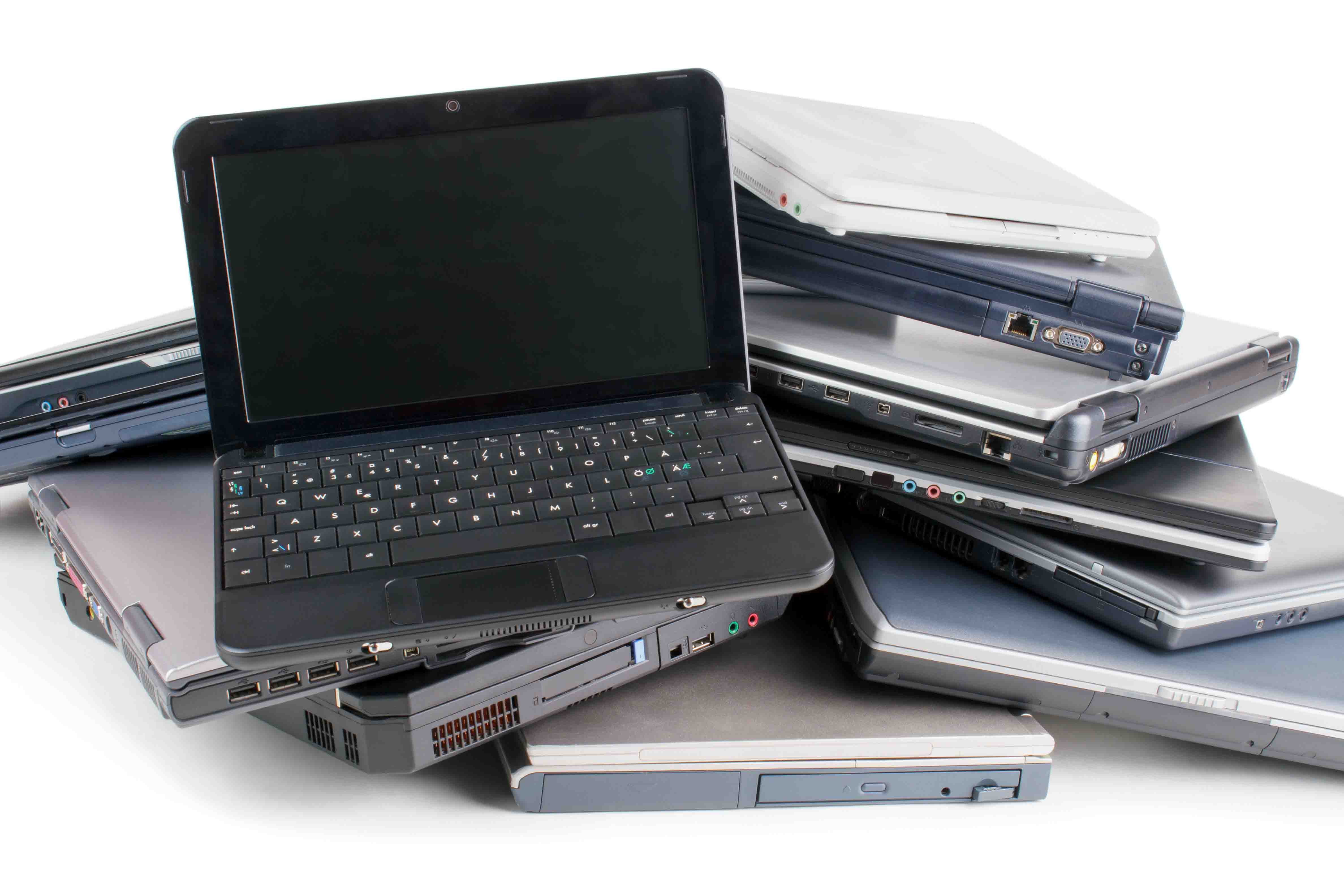 *** Local Caption *** Stack of used laptops for recycle , white background