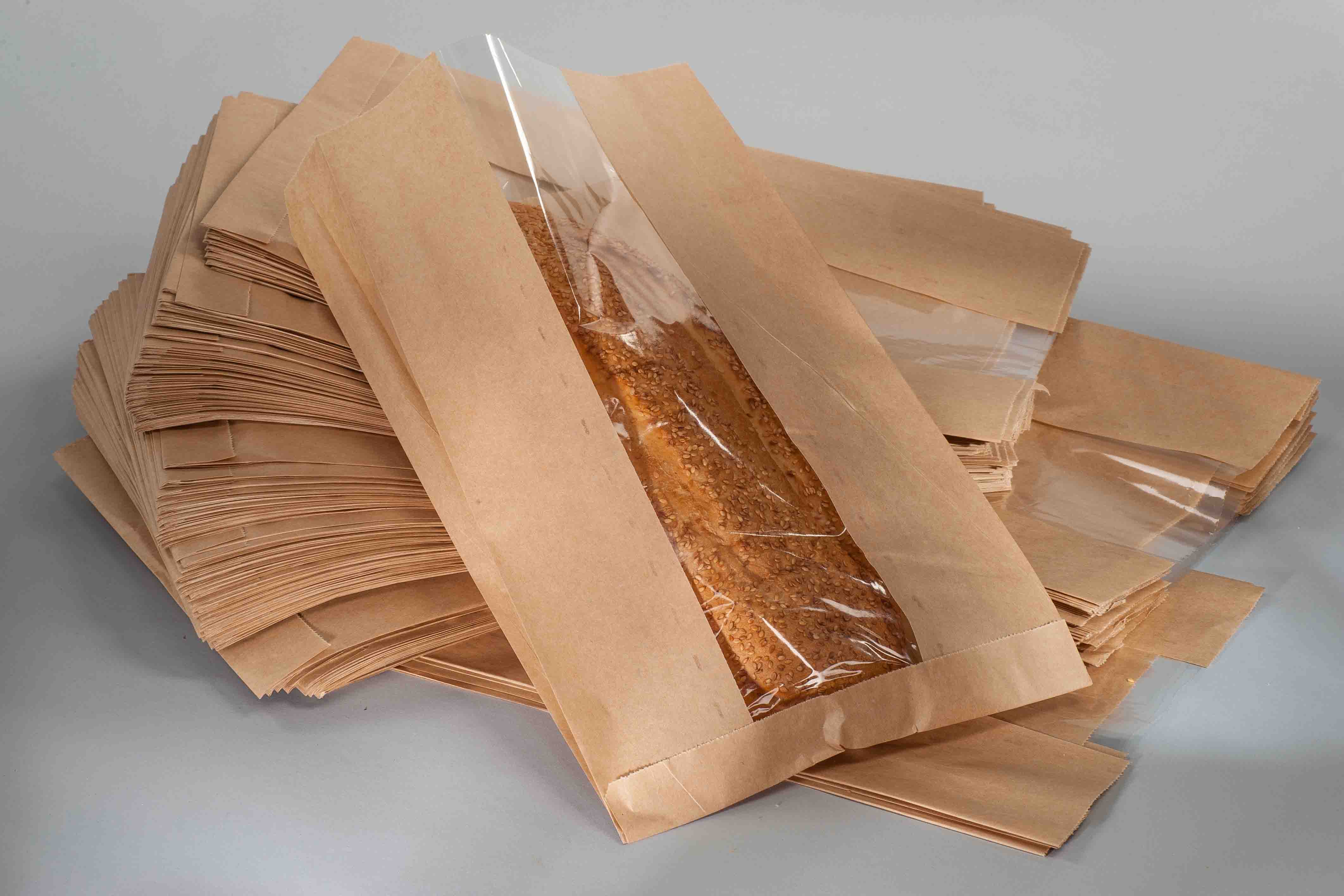 bread baguette with sesame seeds in paper packaging