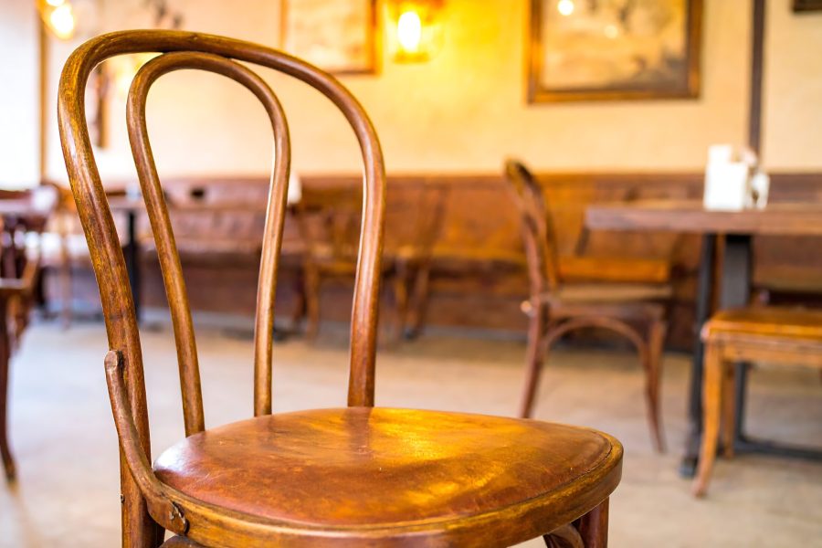 Close-up of a vintage wooden chair in a cozy cafe