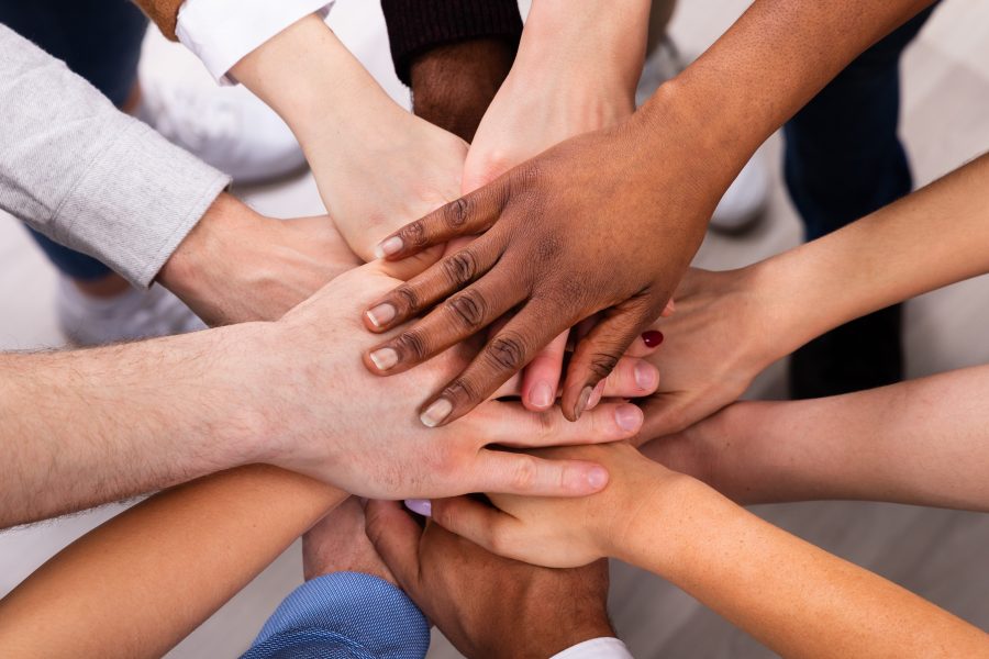 High Angle View Of Multiracial Friend Stacking Hand Together