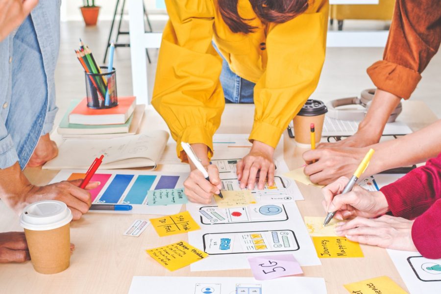 Young Asian business creative team work together, mobile application software design project. Brainstorm meeting, internet technology, smartphone web app designer, office coworker teamwork concept