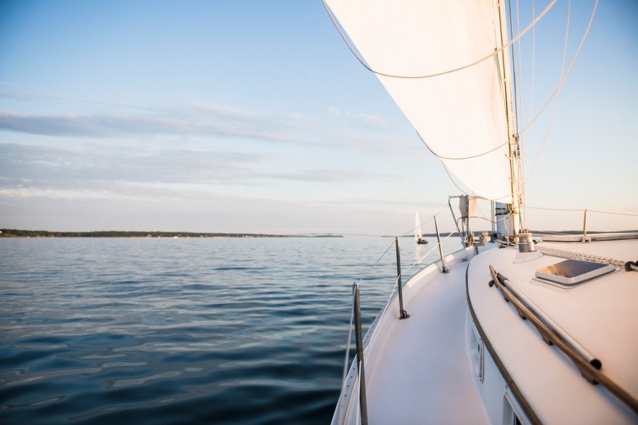 Boat sailing during golden hour summer sunset