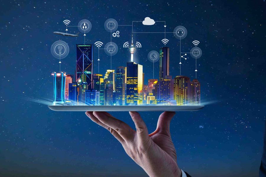 Waiter hand holding an empty digital tablet with Smart city with smart services and icons, internet of things, networks and augmented reality concept , night scene .