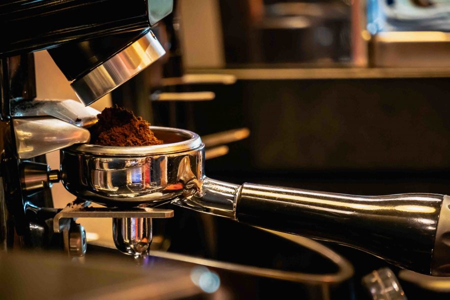 Barista preparing filter holder with coffee flour out of coffee