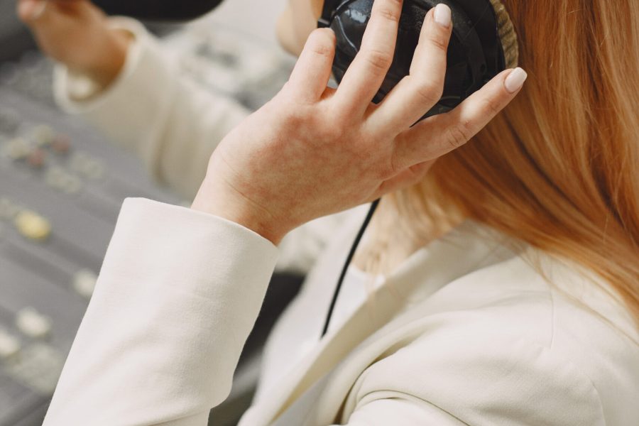 Female host communicating on Microphone. Woman in radio studio.