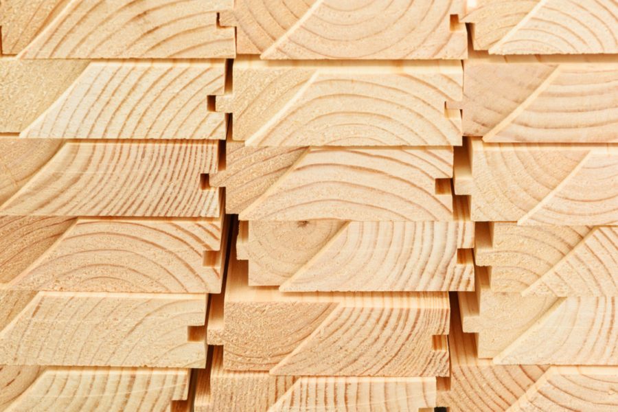 End view of stacked floorboards. Wooden structure closeup.